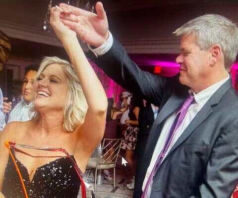 Jennifer dancing with her husband at a celebration